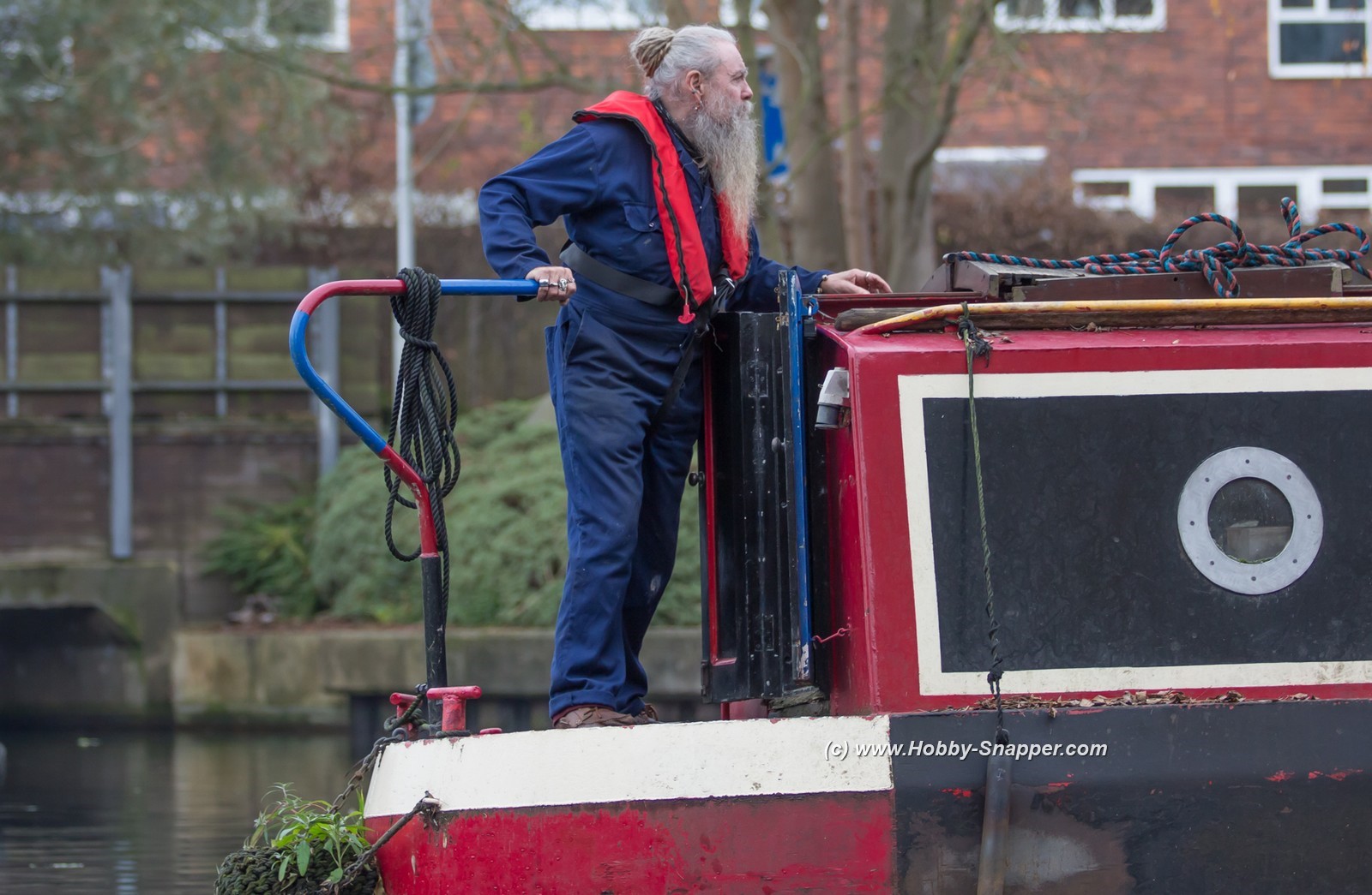 Photo Image Of: Man on a narrow boat.....